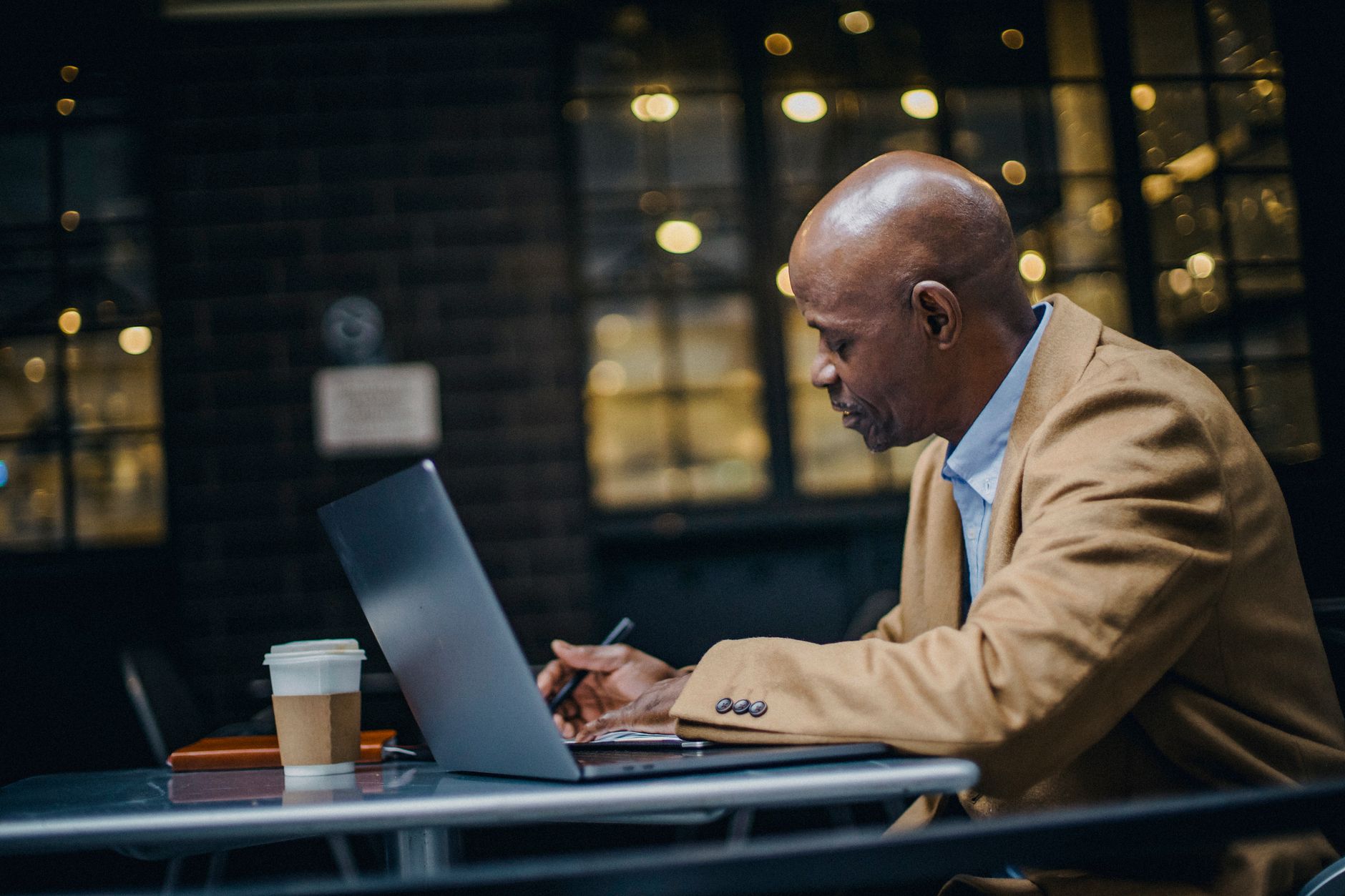 An individual reviewing a personal money plan on a laptop